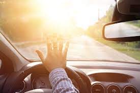 Do you get more sun than you realized in your daily driving? Image of man driving into the bright sun