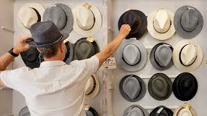 Man choosing a hat from several styles, fabrics and
colors. 